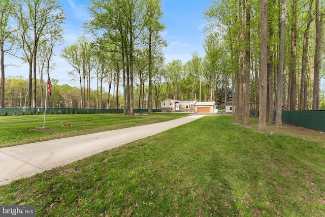 surrounding community with a garage, a yard, and fence