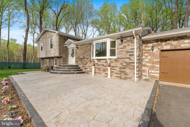 tri-level home with stone siding