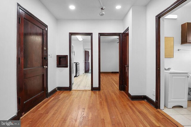 2728 Minnesota Ave SE, Washington, DC 20019 - hall featuring light wood-type flooring, recessed lighting, baseboards, and a sink