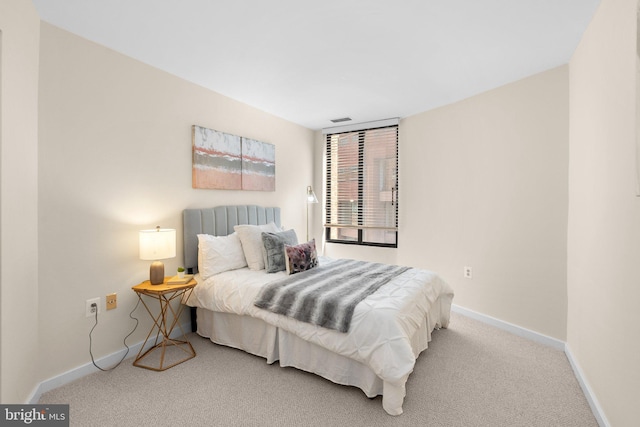 carpeted bedroom with visible vents and baseboards
