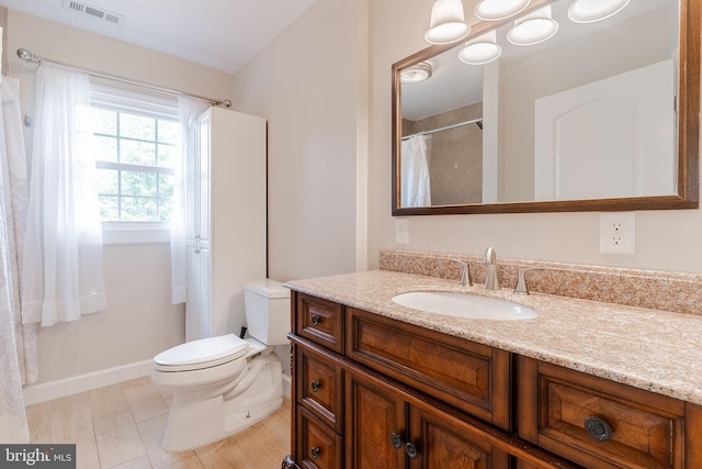 bathroom featuring vanity, toilet, and tile patterned flooring