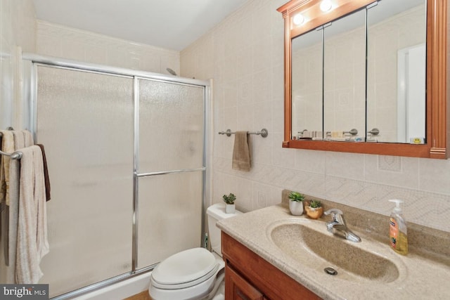 full bath with a shower stall, tasteful backsplash, vanity, toilet, and tile walls