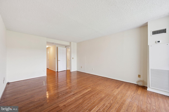 6101 Edsall Rd Unit 1408, Alexandria, VA 22304 - empty room with a heating unit, a textured ceiling, wood finished floors, and visible vents