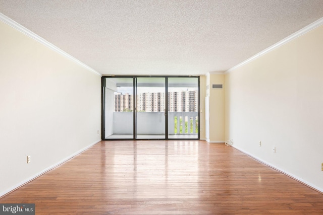 6101 Edsall Rd Unit 1408, Alexandria, VA 22304 - unfurnished room featuring crown molding, a textured ceiling, and hardwood / wood-style floors