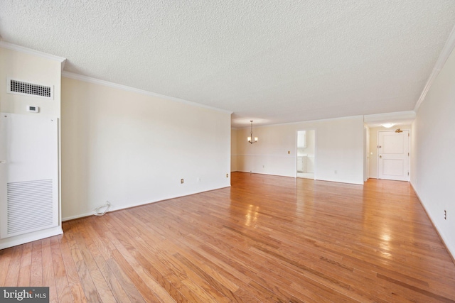 6101 Edsall Rd Unit 1408, Alexandria, VA 22304 - spare room with crown molding, an inviting chandelier, light wood finished floors, a textured ceiling, and visible vents