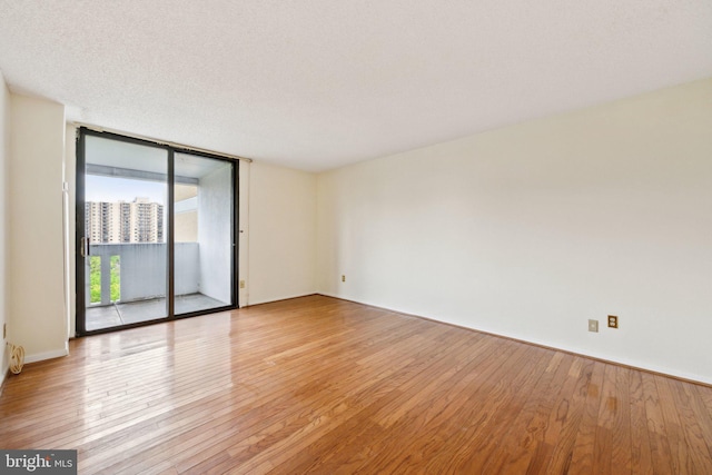 6101 Edsall Rd Unit 1408, Alexandria, VA 22304 - spare room with floor to ceiling windows and light wood-style floors