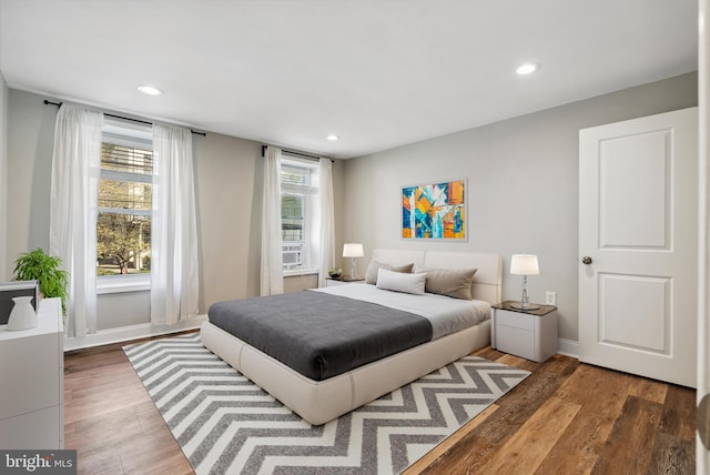 bedroom with recessed lighting, baseboards, and wood finished floors