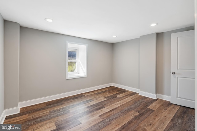 unfurnished room with dark wood-style flooring, baseboards, and recessed lighting