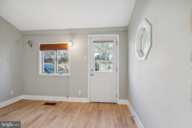 doorway to outside featuring visible vents, a wealth of natural light, light wood-type flooring, and baseboards