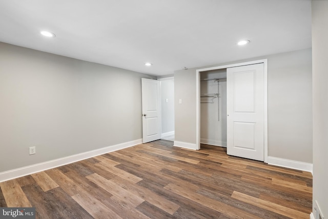 unfurnished bedroom featuring recessed lighting, baseboards, and wood finished floors