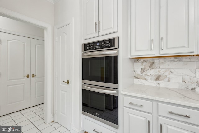 9313 Braymore Cir, Fairfax Station, VA 22039 - kitchen featuring decorative backsplash, stainless steel double oven, light tile patterned floors, white cabinetry, and light stone countertops