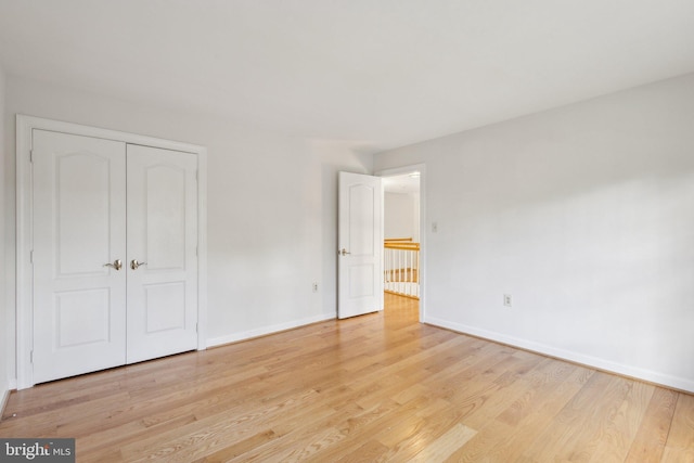 9313 Braymore Cir, Fairfax Station, VA 22039 - unfurnished bedroom with light wood-type flooring, baseboards, and a closet