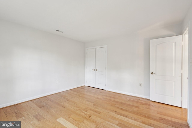 9313 Braymore Cir, Fairfax Station, VA 22039 - unfurnished bedroom with baseboards, a closet, visible vents, and light wood-type flooring