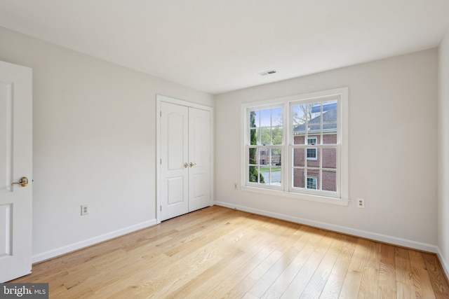 9313 Braymore Cir, Fairfax Station, VA 22039 - unfurnished bedroom featuring baseboards, wood finished floors, visible vents, and a closet