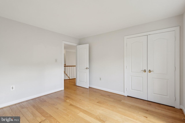 9313 Braymore Cir, Fairfax Station, VA 22039 - unfurnished bedroom with a closet, light wood finished floors, and baseboards