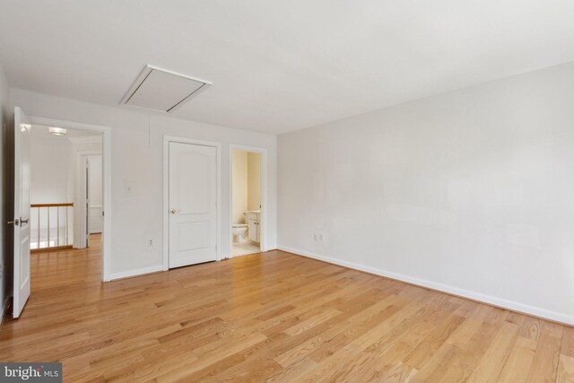 9313 Braymore Cir, Fairfax Station, VA 22039 - unfurnished bedroom featuring attic access, ensuite bath, light wood finished floors, and baseboards