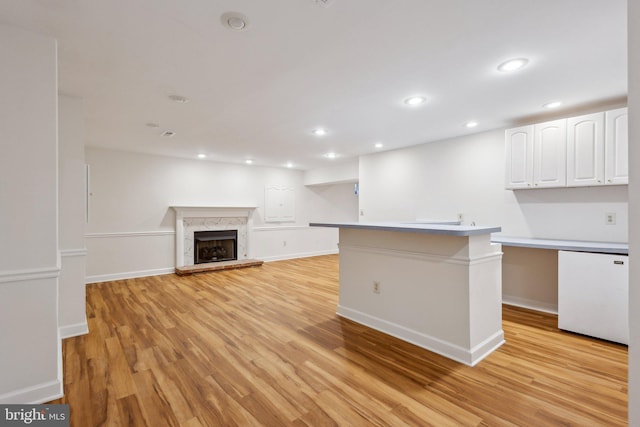 9313 Braymore Cir, Fairfax Station, VA 22039 - kitchen with white cabinets, baseboards, and light wood-style floors