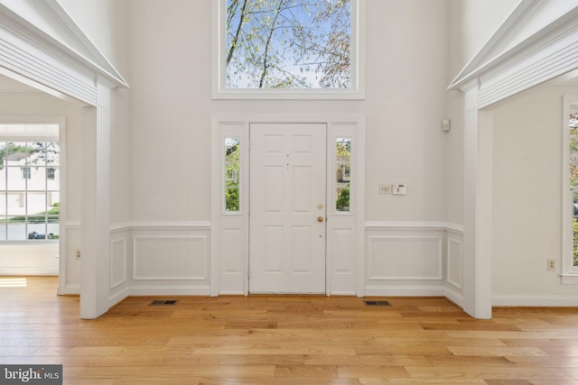 9313 Braymore Cir, Fairfax Station, VA 22039 - foyer entrance with plenty of natural light, visible vents, a towering ceiling, and wainscoting