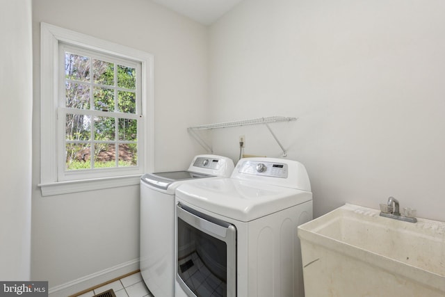 9313 Braymore Cir, Fairfax Station, VA 22039 - washroom with a sink, separate washer and dryer, light tile patterned floors, baseboards, and laundry area