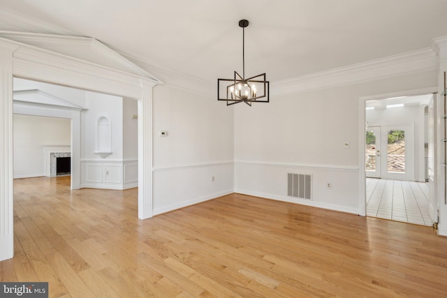 9313 Braymore Cir, Fairfax Station, VA 22039 - unfurnished dining area featuring light wood-style flooring, visible vents, a chandelier, crown molding, and a fireplace