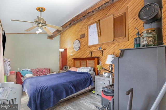 bedroom featuring wood walls and wood finished floors
