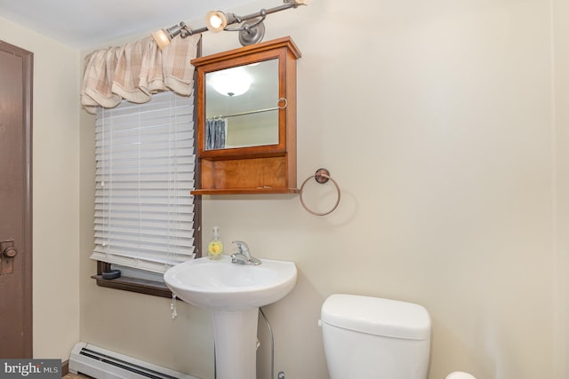 bathroom featuring a sink, a baseboard radiator, and toilet