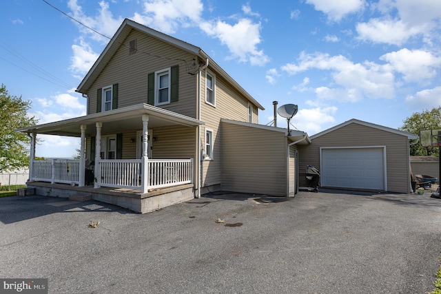 view of front of home featuring a porch, an attached garage, and aphalt driveway