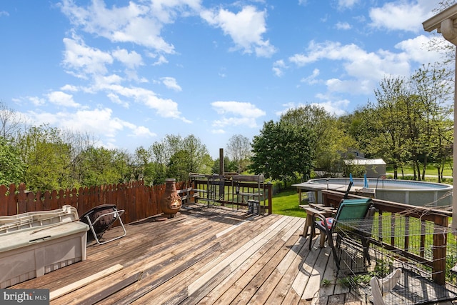deck featuring a fenced in pool