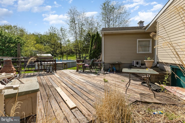 deck featuring a jacuzzi