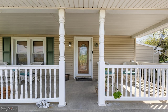 view of exterior entry with a porch