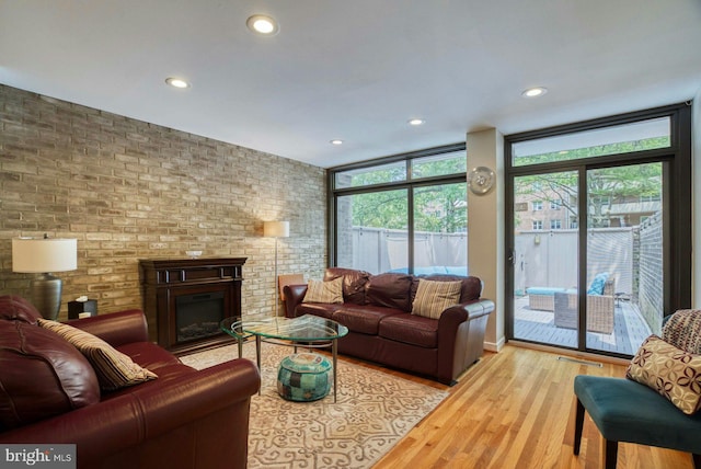 1273 Delaware Ave SW Unit 66, Washington, DC 20024 - living area featuring floor to ceiling windows, recessed lighting, wood finished floors, and a fireplace
