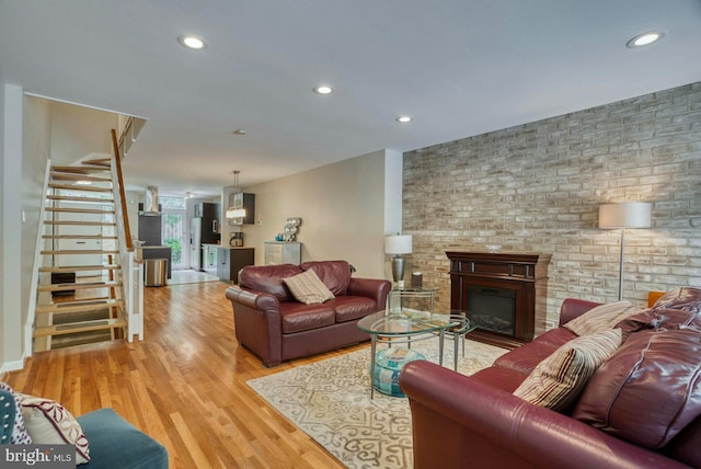 1273 Delaware Ave SW Unit 66, Washington, DC 20024 - living room featuring stairway, a fireplace, wood finished floors, and recessed lighting