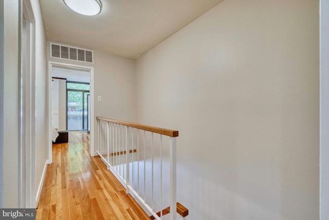 1273 Delaware Ave SW Unit 66, Washington, DC 20024 - hallway with an upstairs landing, light wood-style floors, and baseboards