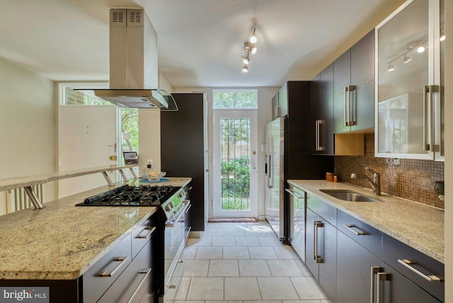 1273 Delaware Ave SW Unit 66, Washington, DC 20024 - kitchen with island range hood, a sink, stainless steel appliances, tasteful backsplash, and light stone counters