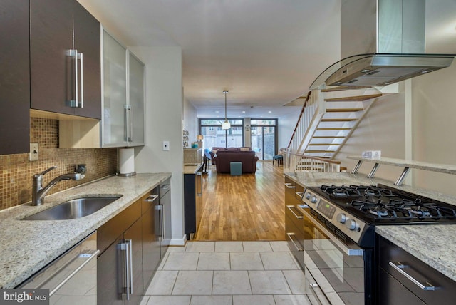 1273 Delaware Ave SW Unit 66, Washington, DC 20024 - kitchen featuring stainless steel appliances, island range hood, a sink, backsplash, and light tile patterned floors