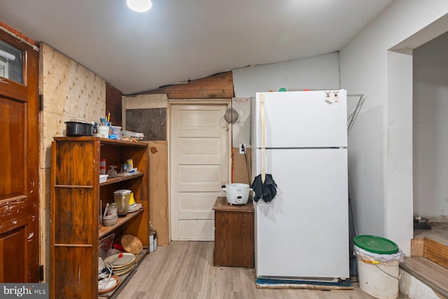 7020 Parsons Ln, Port Norris, NJ 08349 - kitchen with freestanding refrigerator, wood finished floors, and vaulted ceiling