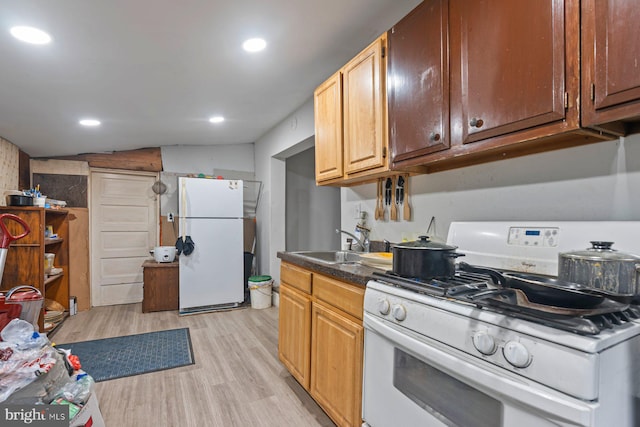 7020 Parsons Ln, Port Norris, NJ 08349 - kitchen with white appliances, a sink, light wood-type flooring, recessed lighting, and dark countertops