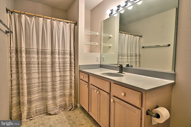 full bath featuring vanity, tile patterned floors, and a shower with curtain