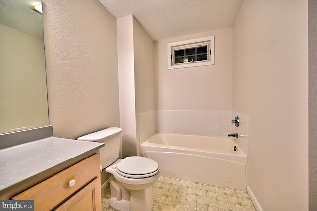 bathroom with a garden tub, a textured ceiling, vanity, baseboards, and toilet