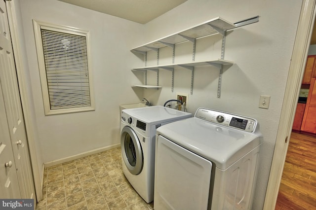 24 Assawoman Ave, Ocean View, DE 19970 - laundry area featuring laundry area, a sink, baseboards, and separate washer and dryer
