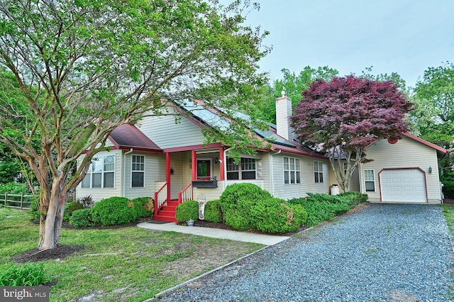 view of front of home with fence, driveway, and a chimney