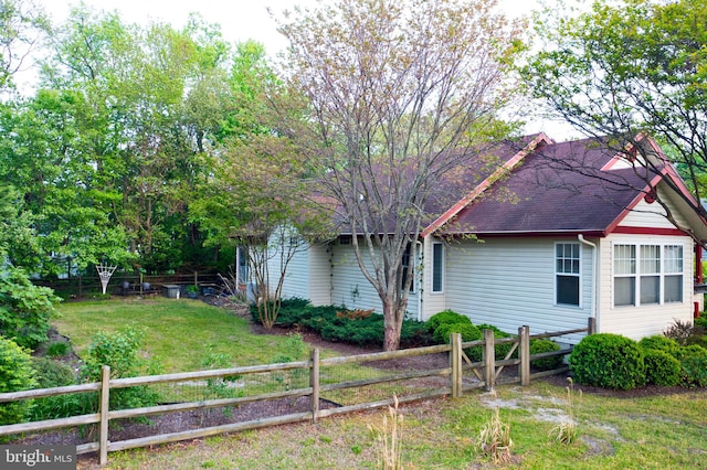 24 Assawoman Ave, Ocean View, DE 19970 - view of front of property with roof with shingles, a fenced backyard, and a front yard