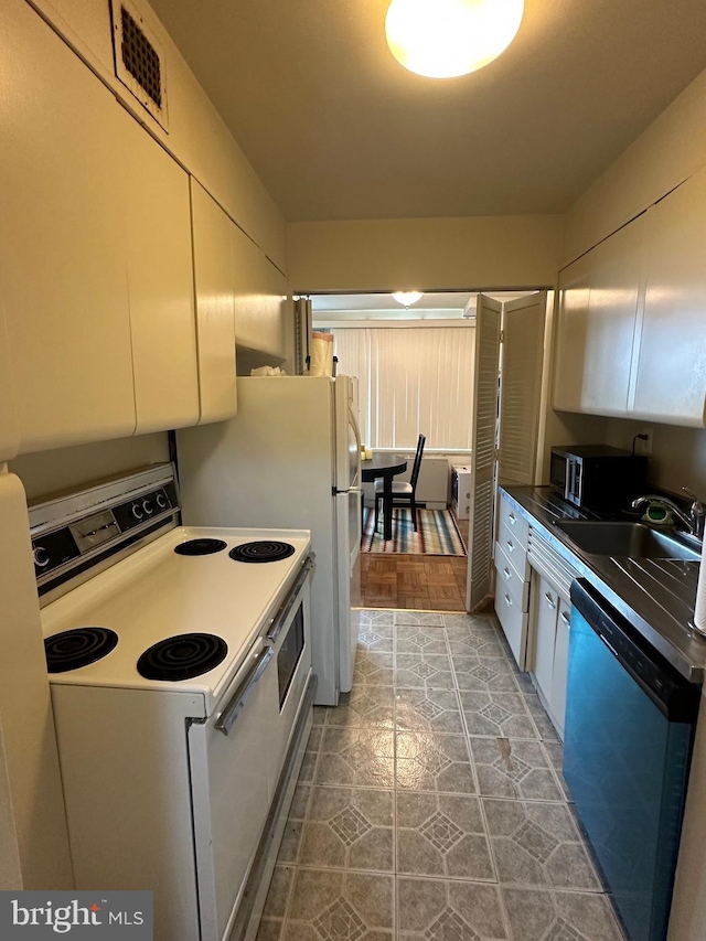 kitchen with visible vents, white cabinets, dishwasher, a sink, and white range with electric cooktop