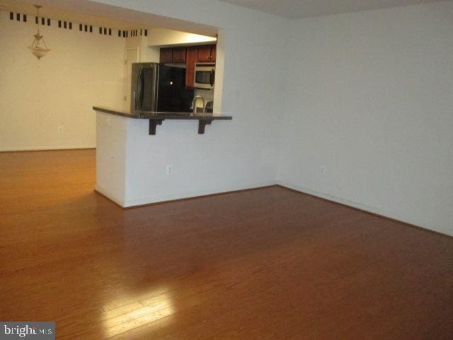 spare room featuring wood finished floors
