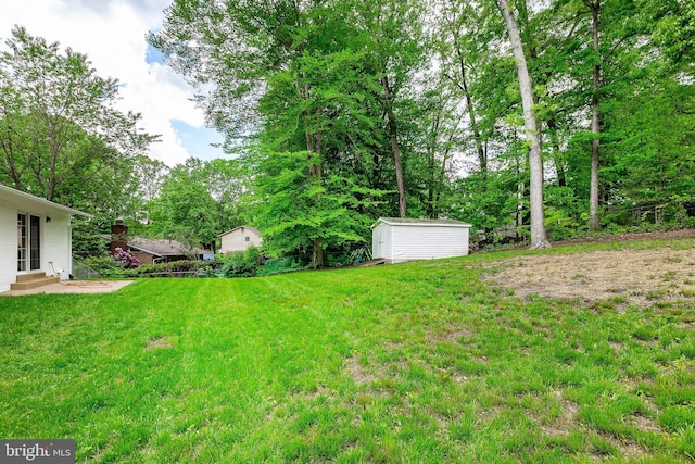 5310 Orchardson Ct, Fairfax, VA 22032 - view of grassy yard with entry steps, a storage shed, and an outbuilding