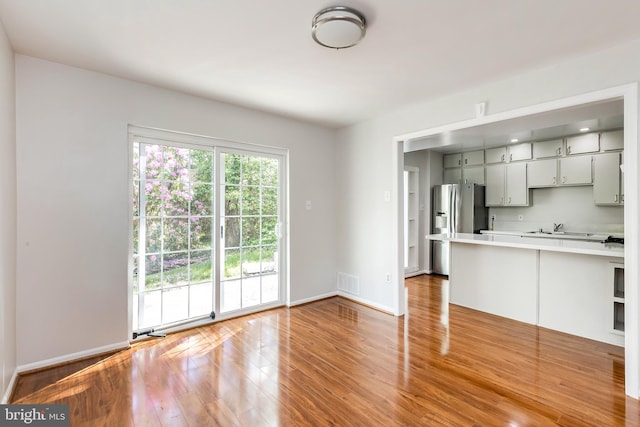5310 Orchardson Ct, Fairfax, VA 22032 - kitchen featuring stainless steel refrigerator with ice dispenser, light countertops, light wood finished floors, a sink, and baseboards