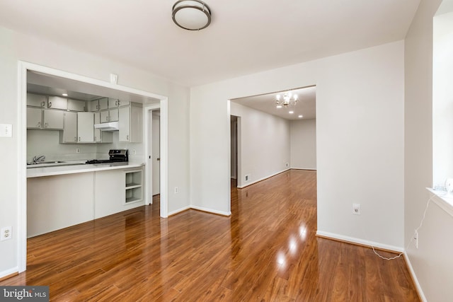 5310 Orchardson Ct, Fairfax, VA 22032 - kitchen with stainless steel electric range, wood finished floors, a chandelier, baseboards, and light countertops
