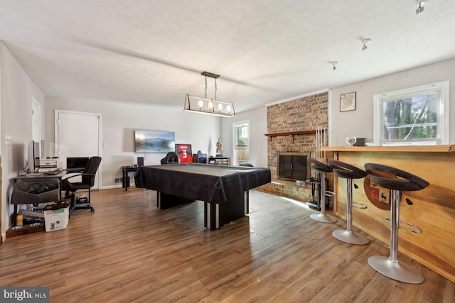 7303 Westwind Ct, Bowie, MD 20715 - playroom featuring a textured ceiling, billiards, wood finished floors, and a fireplace