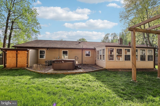 7303 Westwind Ct, Bowie, MD 20715 - back of property with a sunroom, central AC unit, a yard, a hot tub, and a chimney