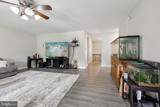 7303 Westwind Ct, Bowie, MD 20715 - living area featuring baseboards, wood finished floors, and ceiling fan